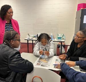  Mrs. MJ explaining project to students